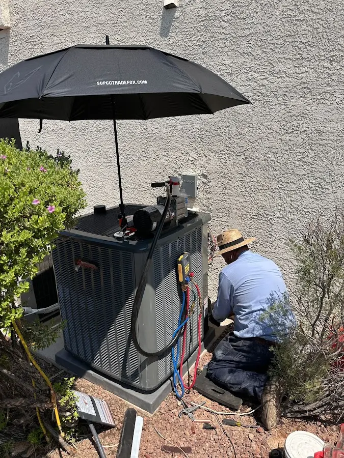 HVAC technician performing outdoor AC maintenance in Wesley Hills